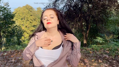 Kinky dominatrix Lara plays with her ample bosom in the park for all to see